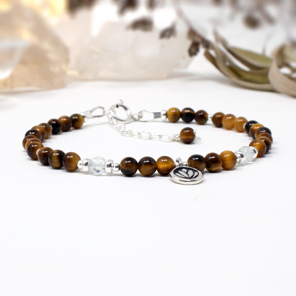 A beaded crystal healing bracelet with real Tigers Eye beads, sterling silver lotus charm and silver accents